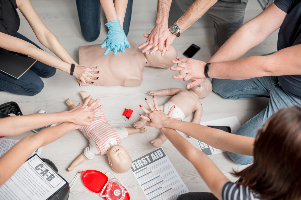 group of government employees practicing CPR in class