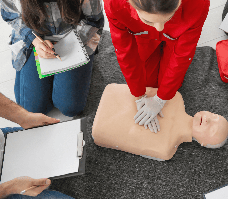 Instructor giving CPR demonstration on mannequin - Onsite Group CPR Instructors