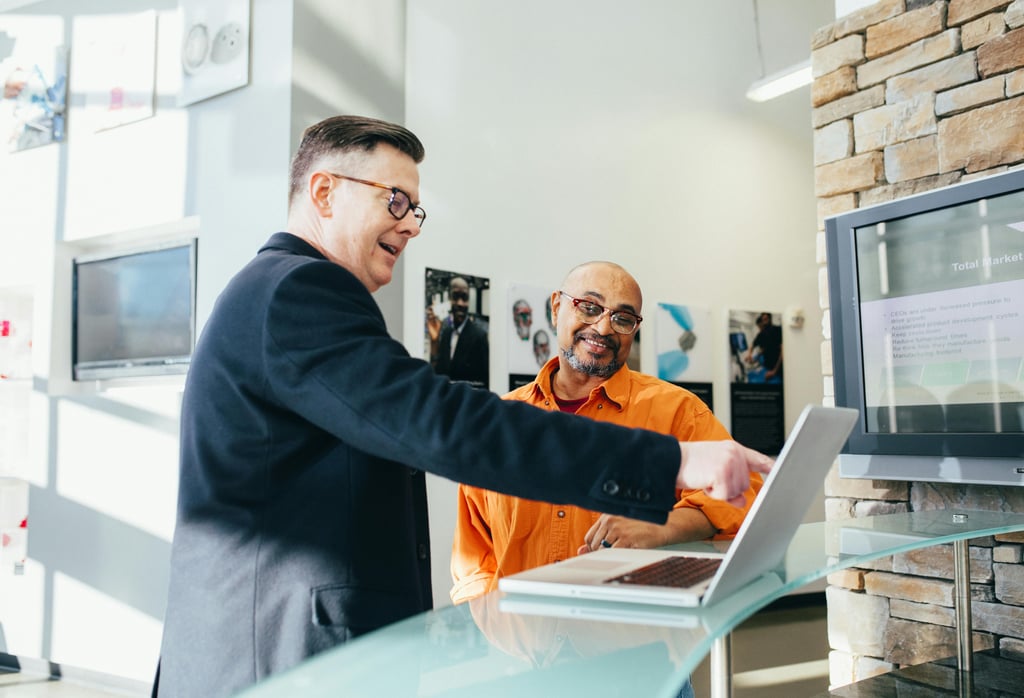 man-pointing-laptop-computer-training-employee