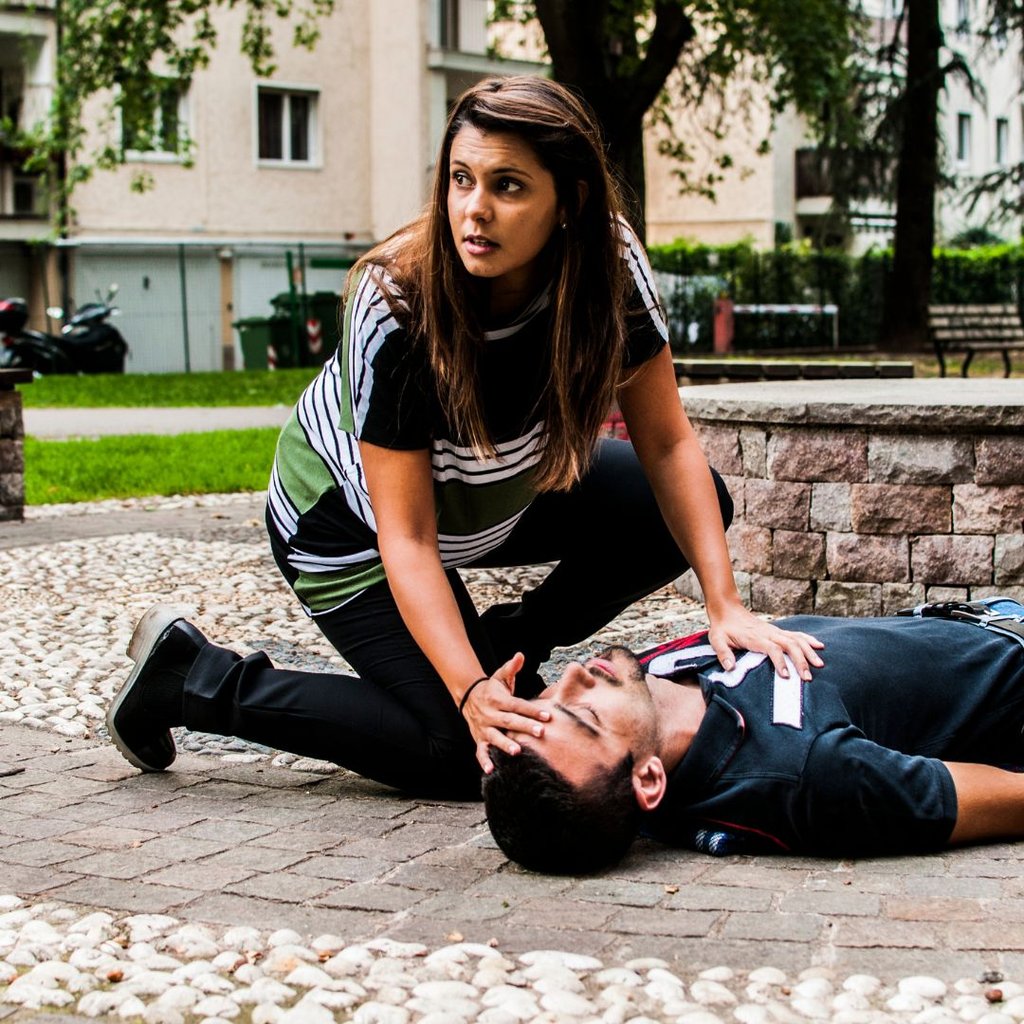 Woman finding a man passed out on ground