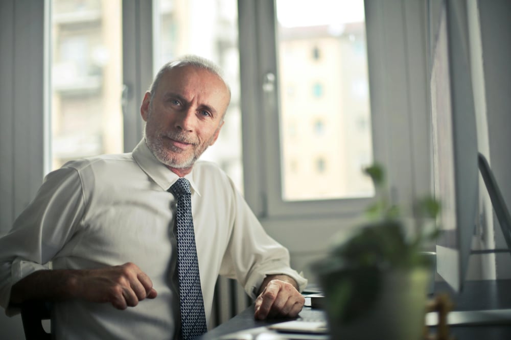 seasoned professional consultant sitting at desk seasoned professional consultant sitting at desk