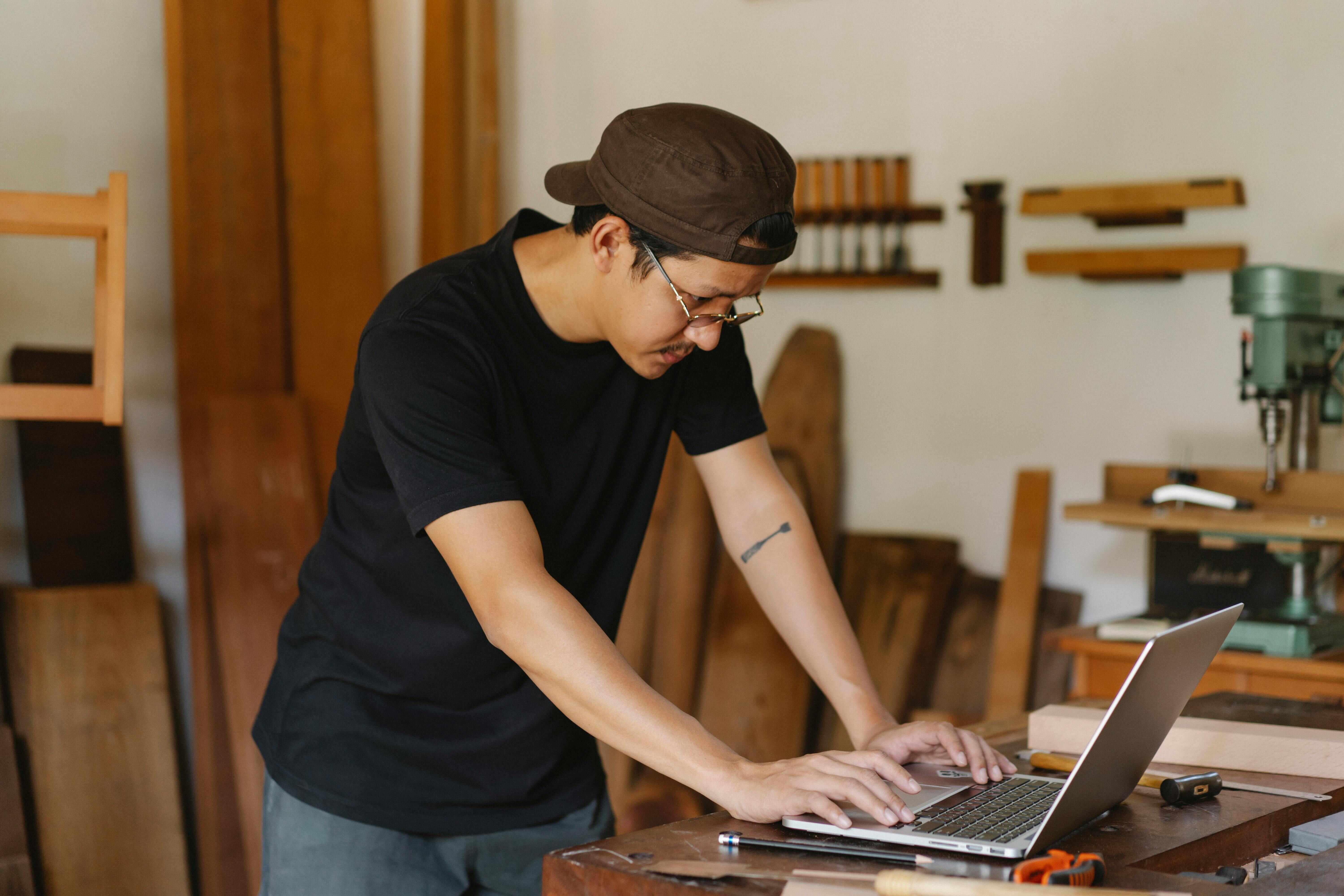 Employee completing online training on a laptop in a workshop
